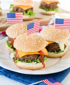 American beef sliders with American cheese on a sesame seed bun.