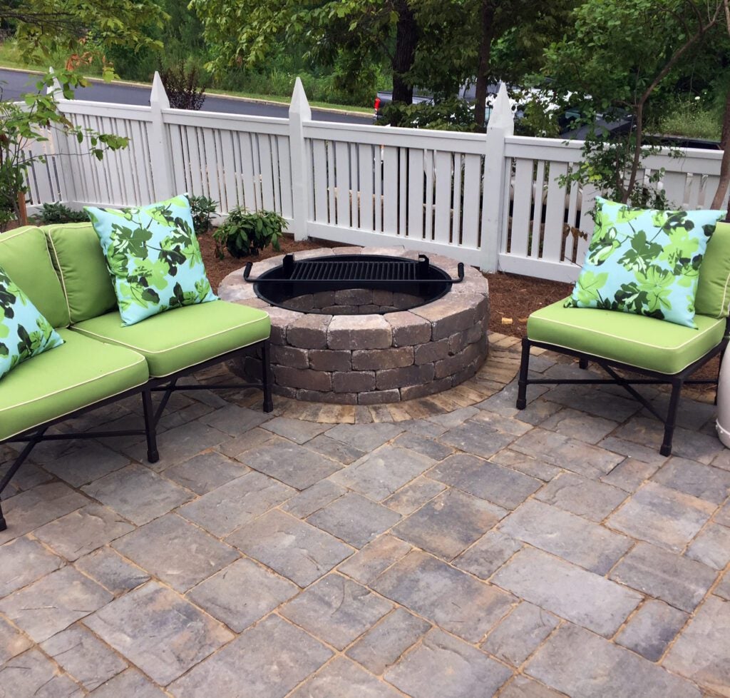 Hardscaped areas include a Mega-Lafitt™ paver patio with a Weston Stone fire pit.