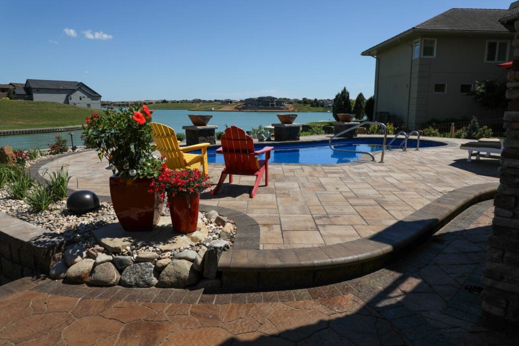 Paver Patio Pool Deck Design Ideas of Poolside Retreat in Bennington, NE