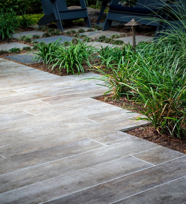 Wood grain porcelain pavers entangled with garden design