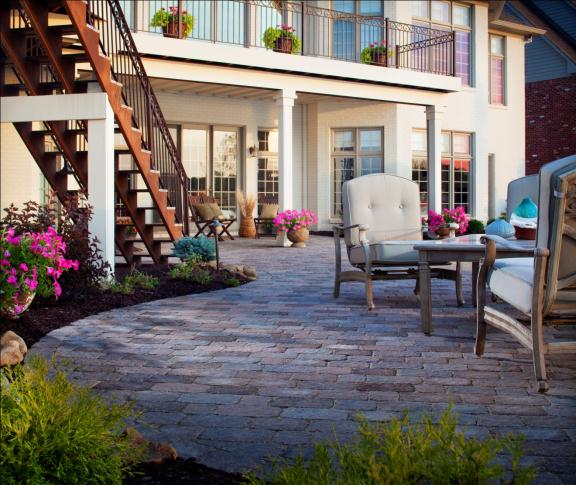 Splashes of color appear throughout this patio in both planted and potted flowers.