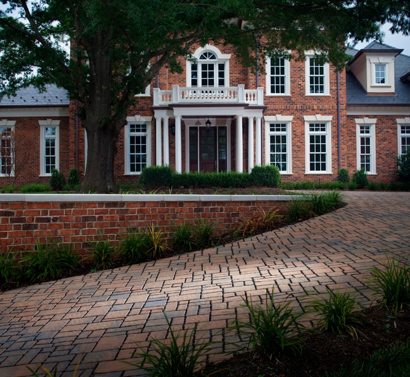 This Subterra permeable paver driveway not only creates a sophisticated entrance to the stately colonial brick home, it quickly drains water ensuring the safety of the steep drive in the heaviest of rainfalls. 