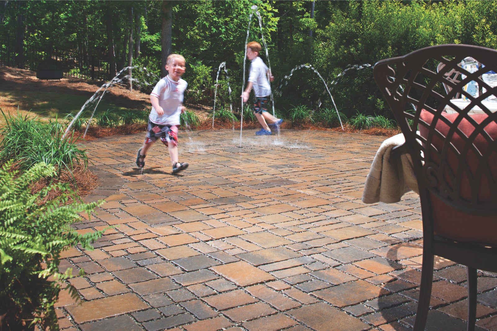 A permeable paver system, like this Subterra Stone® patio, can be designed to include a collection cistern and a pump to harvest water for reuse with water features, irrigation or other greywater uses.