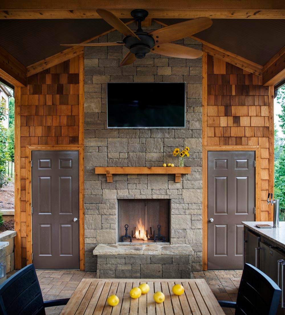 Every electronic aspect of this outdoor living area is controlled by the homeowner's mobile app, including the fan, lighting, TV and the gas starter on the fireplace.