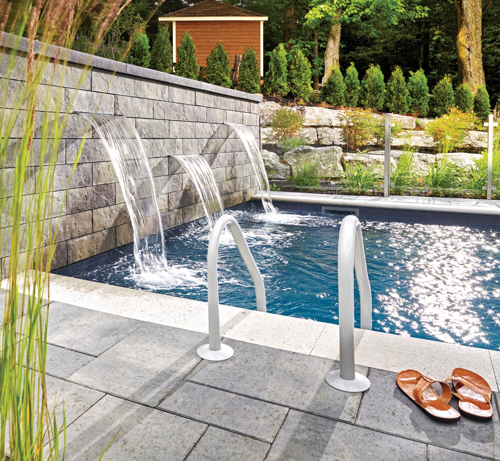Melville™ paver pool deck and Tandem® Wall Waterfall and Pool