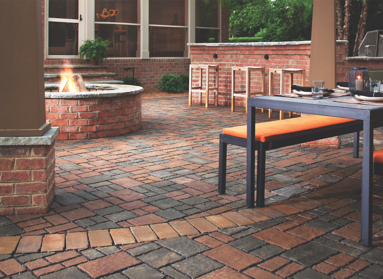This outdoor living design incorporates several of the most popular trends this year: permeable pavers, fire pit, 