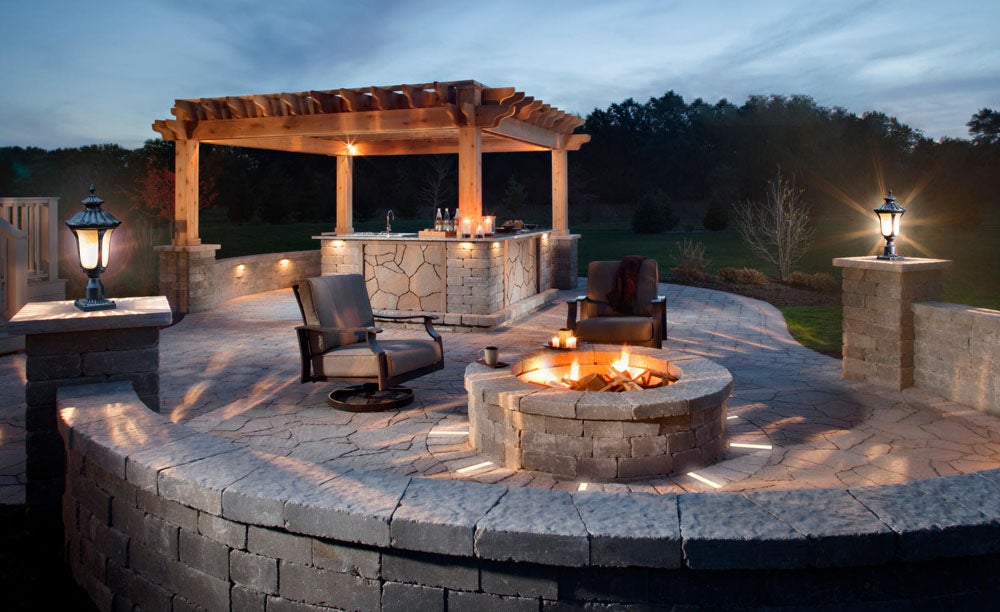 Outdoor lighting with paver lights, firepit and pillar lights