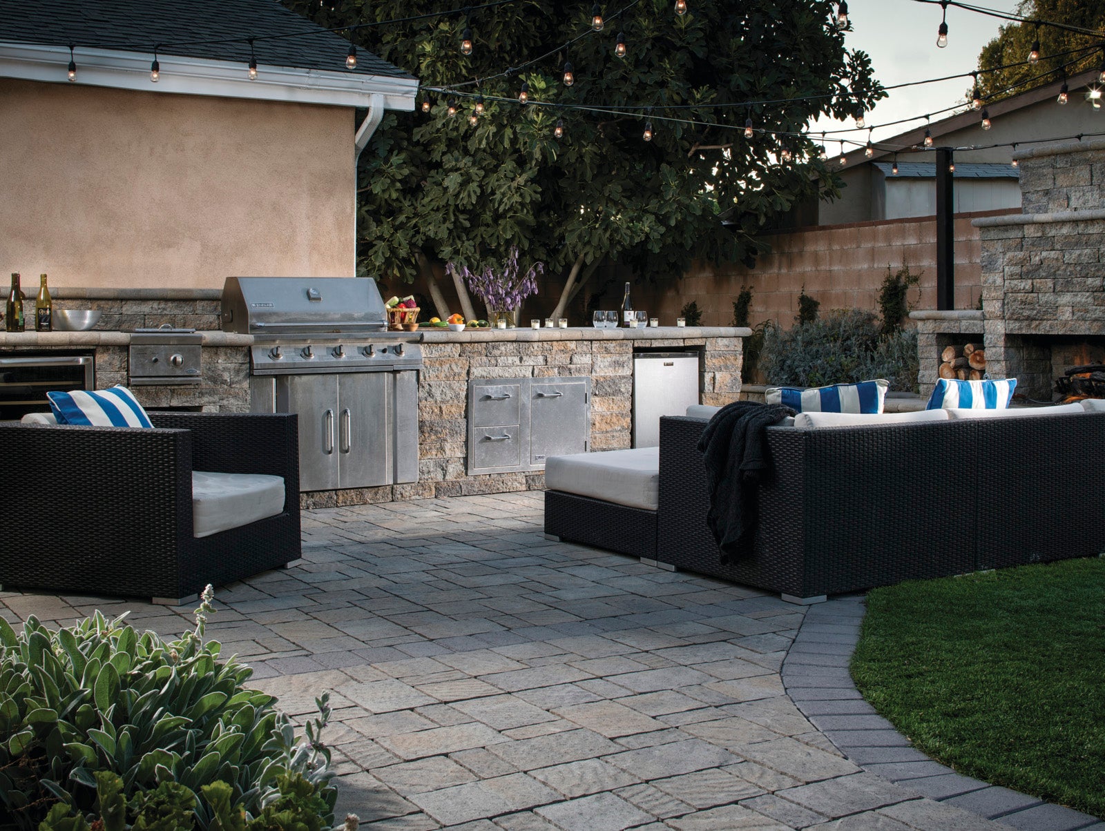 This outdoor kitchen design incorporates drought-tolerant plants, 