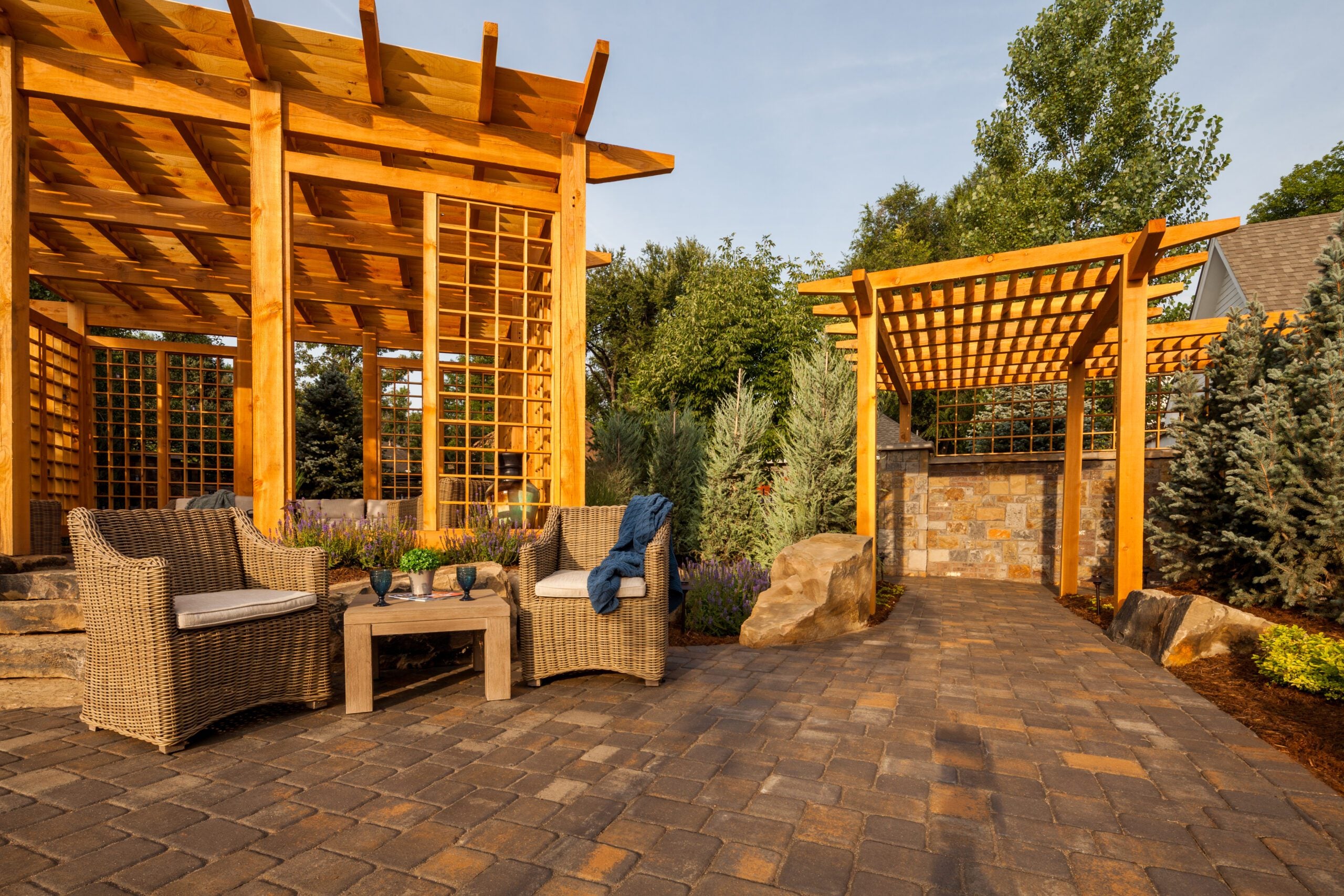 paver hardscape design and backyard patio with dual arbors