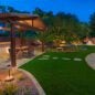 outdoor living space with turf and pergola