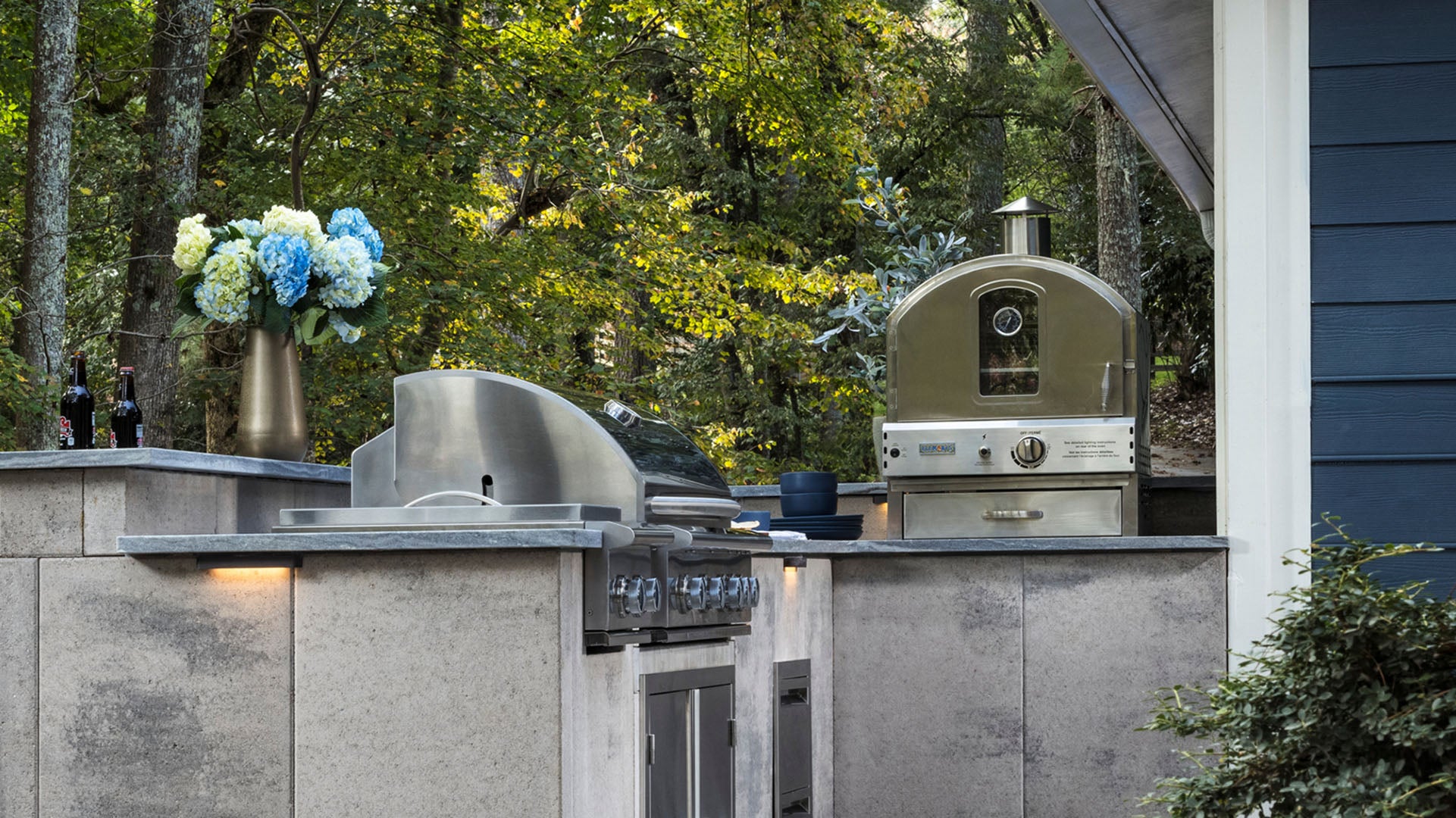 outdoor kitchen with grill and pizza oven