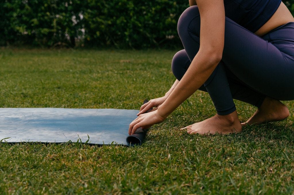 woman doing yoga in the grass