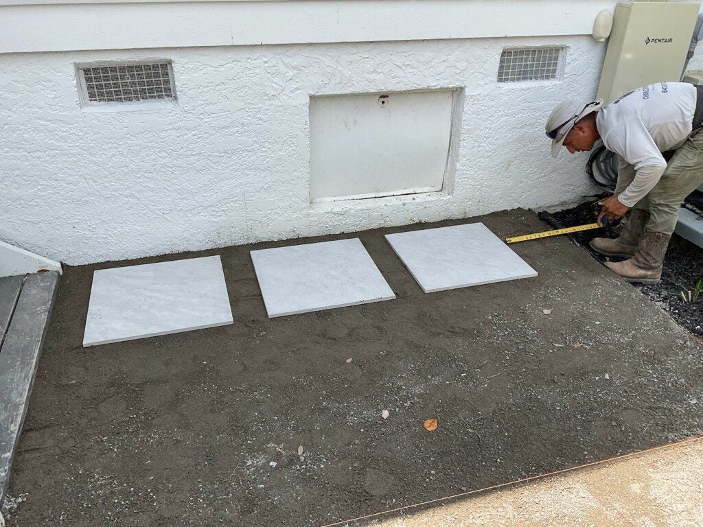 Belgard pavers being placed in Megan's yard