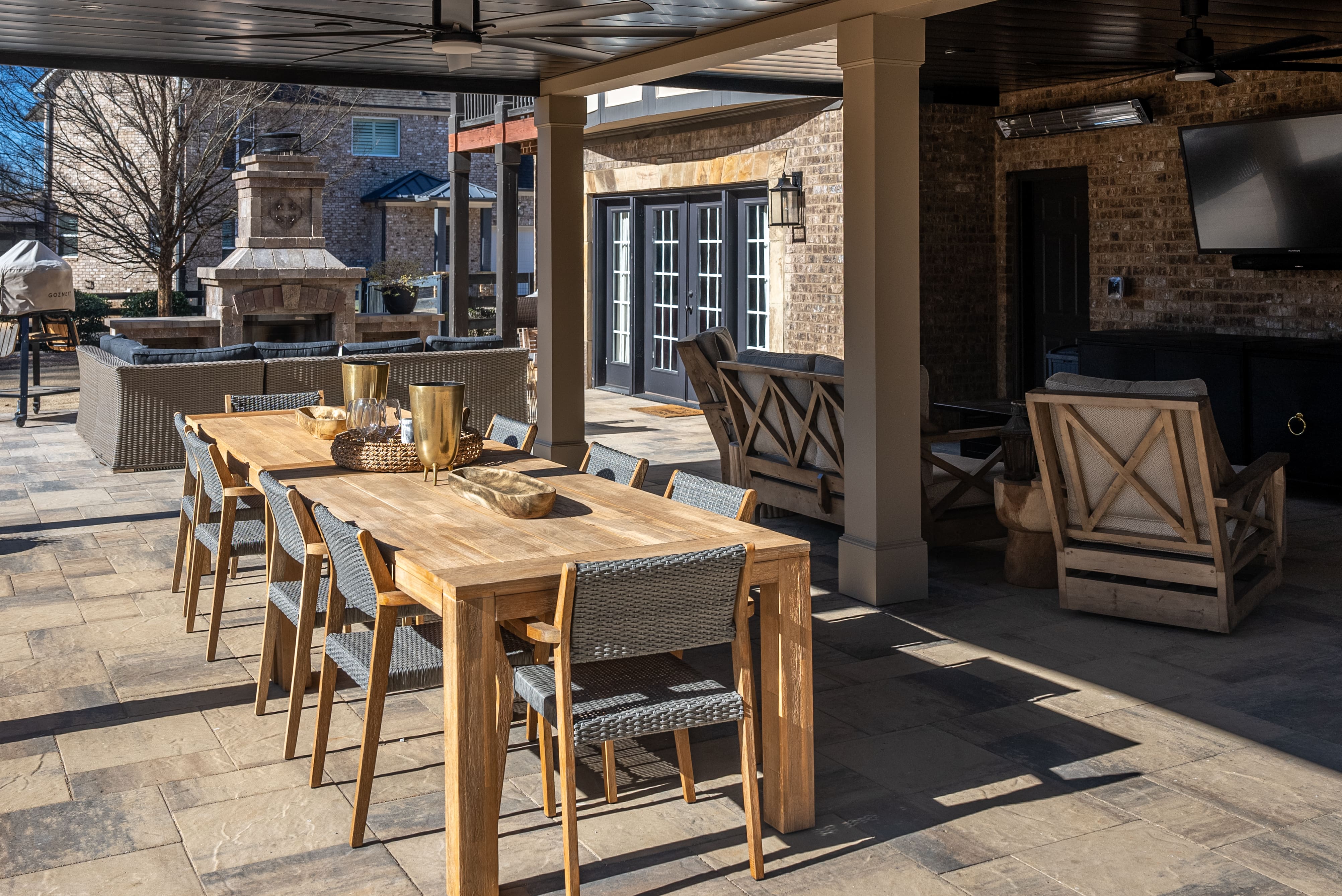 outdoor living area with an outdoor dining table and outdoor dining chairs and a seating area to the right of the table