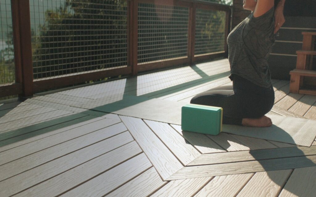 woman doing yoga in her backyard
